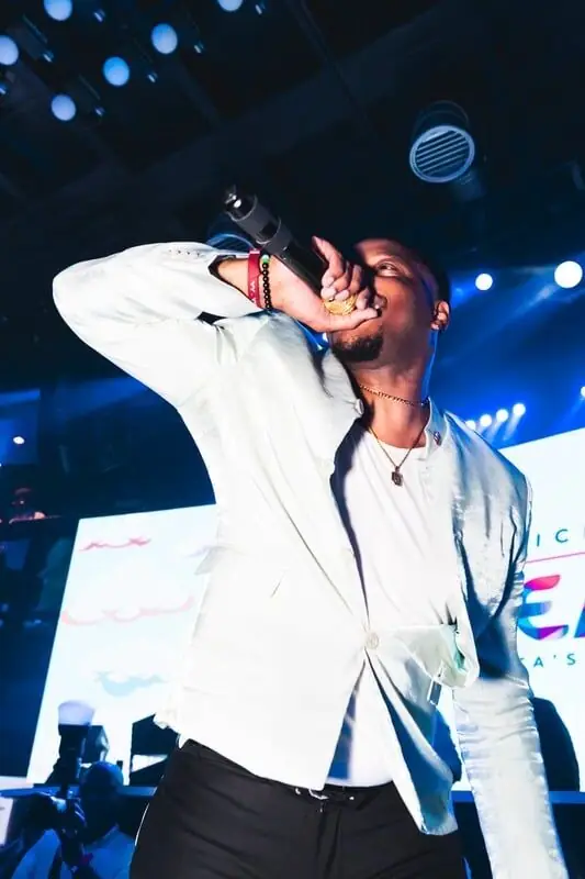 Jovan emceeing on a concert stage
