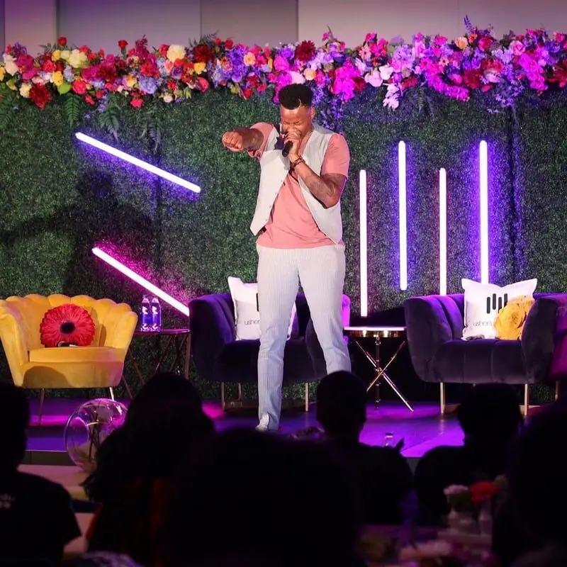 Jovan on a lit stage
