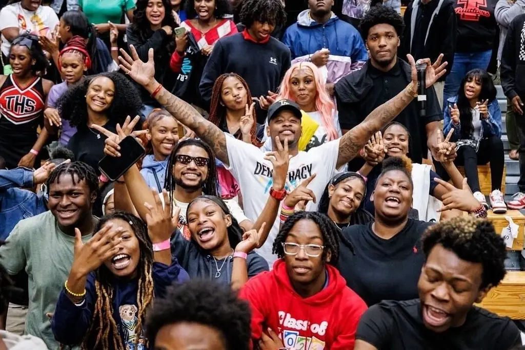 Students cheering with hands up