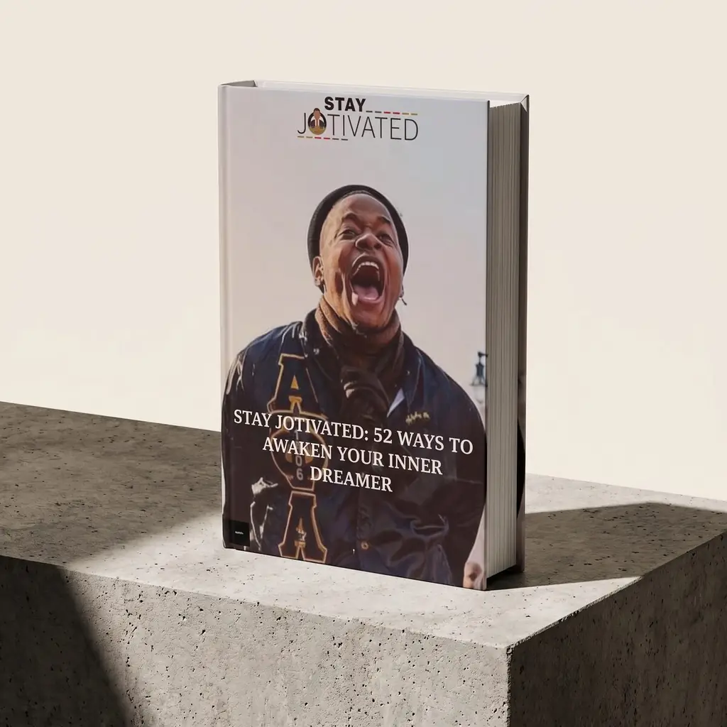 Stay Jotivated: 52 Ways to Awaken Your Inner Dreamer, hardcover on a concrete plinth